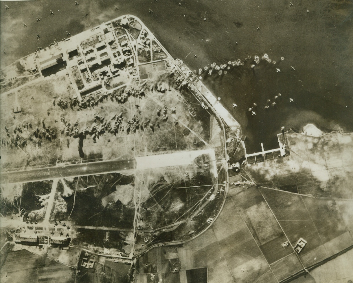 AMERICAN BOMBERS RAID SARDINIA, 2/24/1943. CAGLIARI, SARDINIA—Two strings of bombs from Flying Fortresses and Martin Marauder bombers of the U.S. Army Air Forces fall on the airdrome at Cagliari, damaging Axis sea and land planes, during a daylight attack. All of our bombers, protected by Lockheed Lightning Fighters, returned from the raid safely. Credit: U.S. Army Air Force photo from Acme;