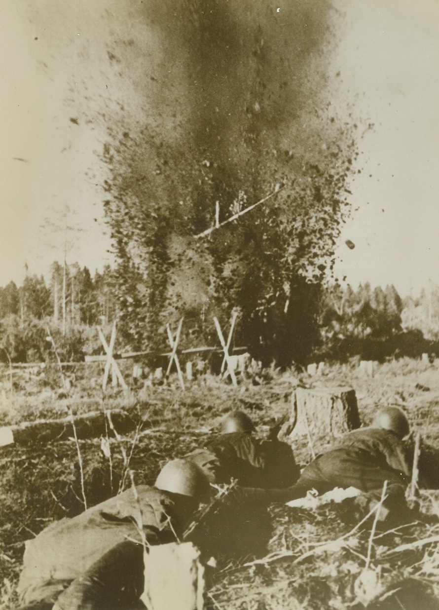 Red Sappers Prepare the Way, 2/1/1943. Southern Russian Front—An explosive charge, set by Russian sappers, (foreground), goes off making a hole in Nazi barbed-wire defenses, clearing the way for a Red advance. Along almost the entire Russian front, Nazis are being pushed back. This photo, just received in New York, was taken recently on the southern front. (Passed by censors). Credit: ACME.;