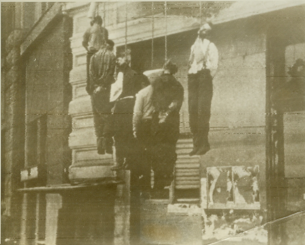 To Be Revenged, 2/21/1943. Somewhere in Russia—Another evidence that Nazi troops take pride in the atrocities they commit is this photo of hanged Red citizens found on a dead German fighters. To forever quell resistance, Hitlerite hangmen methodically exterminate populations of villages they capture. Soviets are getting their revenge on the battlefields. Credit: ACME radiotelephoto;