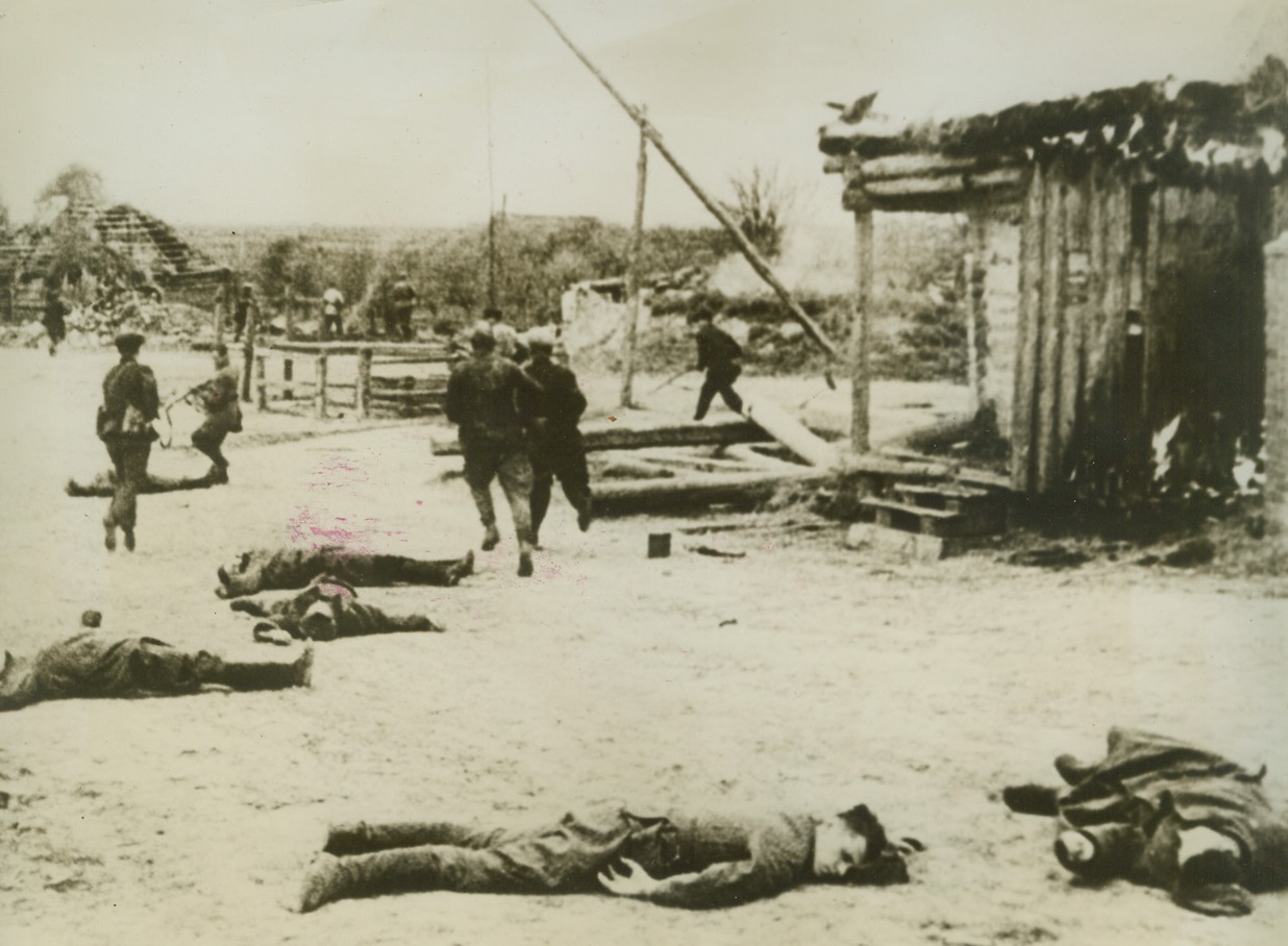 Dead Men Litter the Streets, 3/5/1943. Flash from “one day of war”.  This photo is from the march of time’s “One Day of War”, a documentary film of one day on the far-flung Russian front, recorded by soldier-photographers of the Red Army.  Of the 160 photographers assigned to the job, thirty were dead before the day ended. Photo shows: Side-stepping dead Germans and Hungarians, whose bodies litter the street of a Russian village, Soviet guerillas pursue the fleeing foe through the town. Credit line (March of Time “One Day of War” photo from ACME);