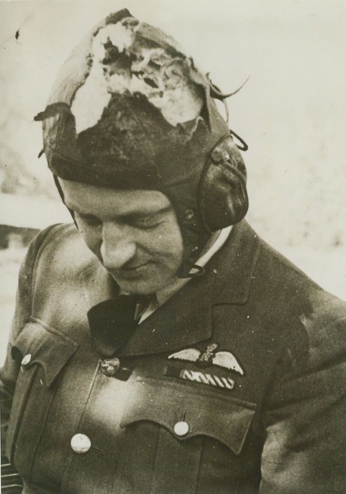 BETWEEN HIM AND DEATH, 5/23/1943. This shredded leather helmet is all that stood between Wing Commander Arthur Hay Donaldson and death when he led a flight of whirlwind fighters in a recent low-level attack on Morlaix airfield. Explosive shells from a ground battery reached his plane, and one went through his cockpit hood and tore through his helmet. Uninjured, the RAF man was knocked unconscious, but he soon recovered to keep his Whirlwind from crashing and fly back across 100 miles of channel to his base. Credit: ACME;