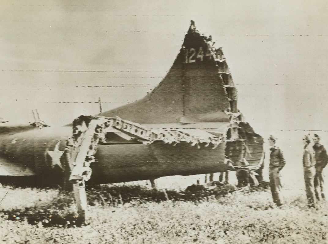 “Wounded” Warbird Comes Home, 5/21/1943. American fliers examine the battered tail section of an American Flying Fortress that managed to return to its home base in spite of damages that crippled it. The “wounded” warbird made its spectacular flight back after participating in a raid on Palermo, Sicily. Credit: U.S. SIGNAL CORPS RADIOTELEPHOTO-ACME.;