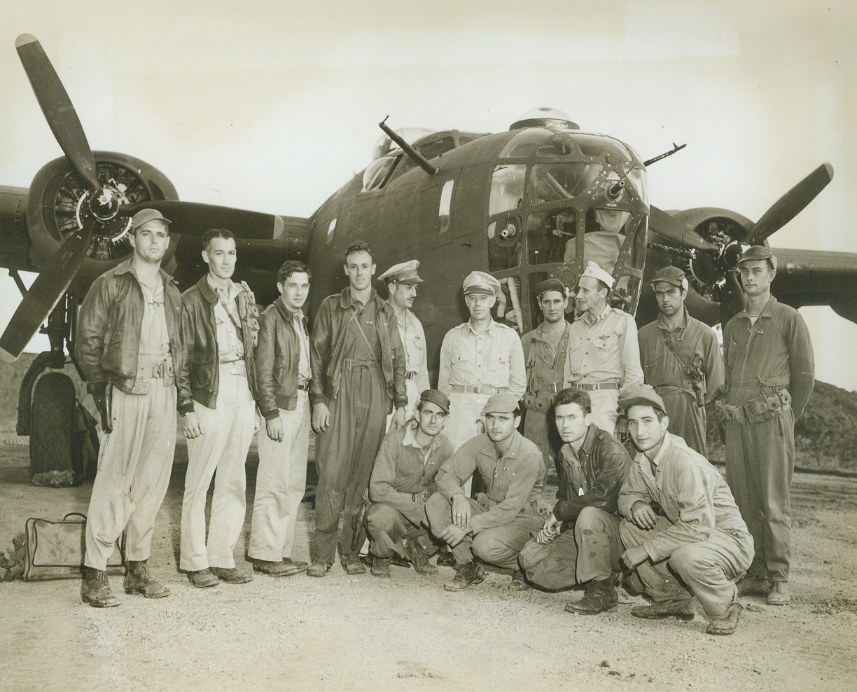 Speedy Awards, 6/6/1943. New Guinea – As U.S. fliers stepped out of their bomber on their return from blasting an 8,000-ton enemy transport, they were met by General George C. Kenney, Commander of allied Air Forces in the Southwest Pacific, who decorated them with air medals immediately.  Right after the awards were made, in New Guinea, General Kenney posed with the heroic crew of the B-24 bomber.  (left to right, standing): 2nd Lt. John H. Sturgeon, pilot, Lexington, Ky.; 2nd Lt. Thomas C. Hanzel, copilot, Mankato, Minn.; 2nd Lt. Bernard W. Rapasky, navigator, Elizabeth, N.J.; 2nd Lt. William A. Woods, bombardier, Louisa, Ky.; Col. Roger M. Ramey (not crew member), Commander of the 5th Airforce; Lt. Gen. George C. Kenney; Staff Sgt. Edward A. Coppins, gunner, Detroit, Mich.; Colonel Ralph L. Koon, (not crew member), Commander of the 90th bomb group; Staff Sgt. Thomas C. Clonch, gunner, Dixie, W. Va.; Staff Sgt. Earl S. Sasser, gunner, Mount Olive, N.C.; (left to right, kneeling) Sgt. E.W. Palmer, weather observer, Elmira, N.Y.; Tech Sgt. E.J. Thompson, radio operator, Coeur D. Alene, Idaho; Tech Sgt. Samuel E. Swift, engineer, Chicago, Ill., and Sgt. J.A. Botteau, photographer, Southbridge, Mass. Credit line –WP- (ACME);