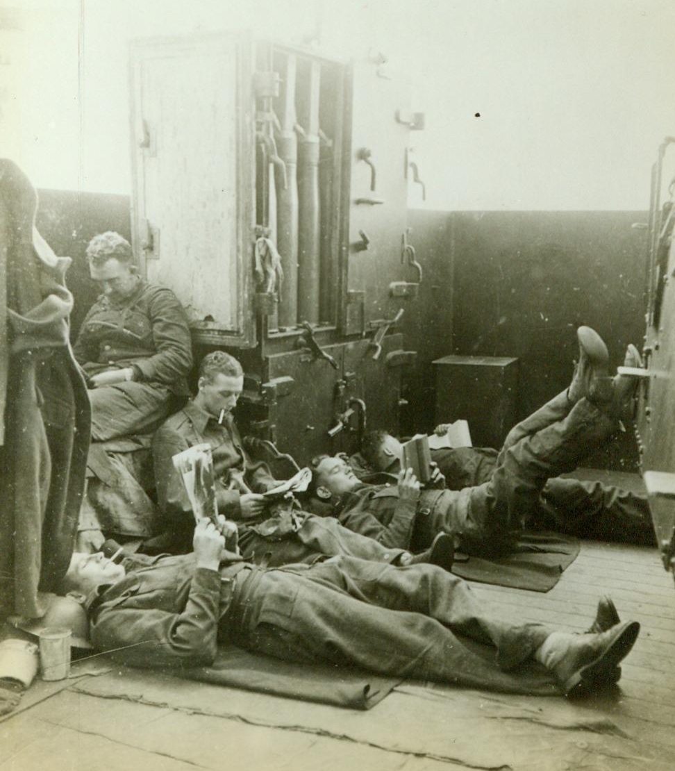 Taking It Easy, 1/17/1943. Aboard A British Cruiser – Men aboard a British cruiser that accompanied a United Nations convoy to Malta take time out for a bit of relaxation and reading during a lull in enemy activity 1/17/43 Credit Line (ACME); Aboard A British Cruiser – Men aboard a British cruiser that accompanied a United Nations convoy to Malta take time out for a bit of relaxation and reading during a lull in enemy activity 1/17/43 Credit Line (ACME);