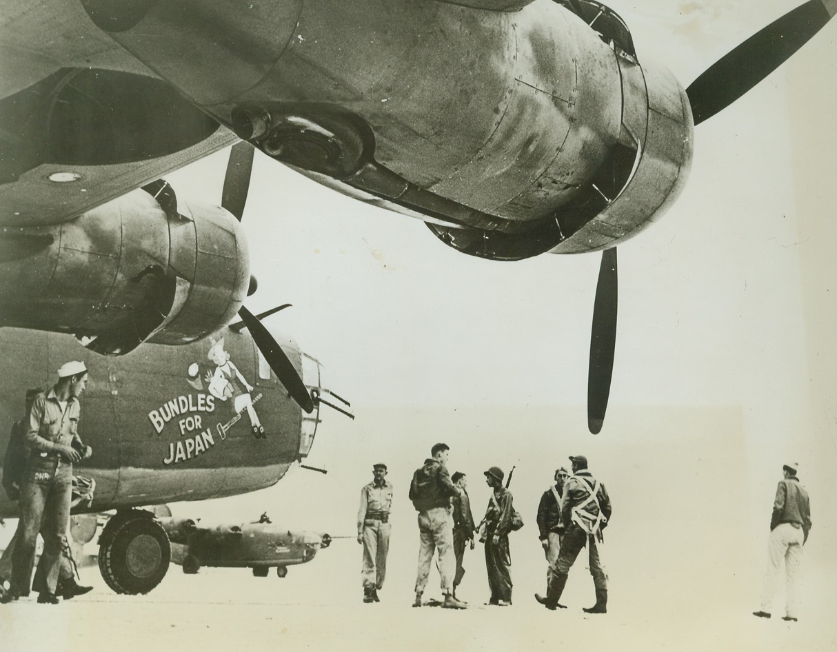 They poured it on Jap-held Wake Island, 1/4/1943. “at an unidentified U.S. advance base in the Pacific”, crew members of an Army Air Force bomber stand under the wing of their ship before taking off for a Christmas eve bombing attack on Wake island, scene of the gallant Marine stand a year ago.  In this raid, 76,000 pounds of bombs were dropped on the Jap-held island (Not to Editors: Do not mention type of bomber shown) Credit (7th Air Force photo from ACME);