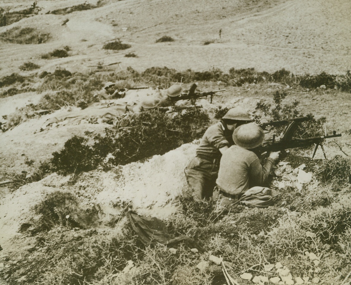 Bren Gunners Hold Hill Top in Tunisia, 1/7/1943. Mateur, Tunisia - - British Bren gunners hold hill top position near Mateur, during recent heavy fighting between axis and allied forces.  Mateur, was first taken by United Nations troops, then later recaptured by the Germans. Credit line (ACME);