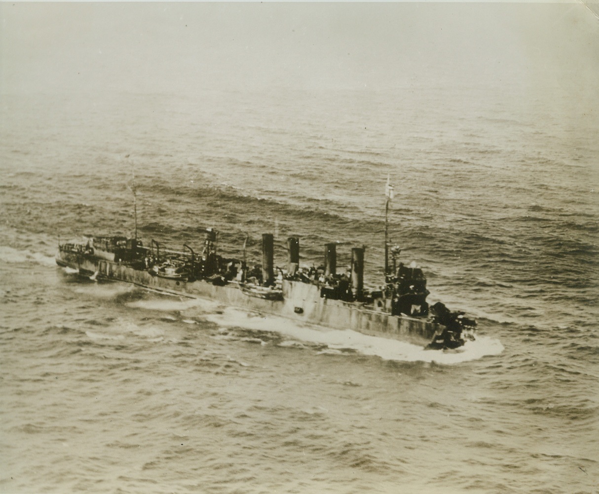 Minus a Bow-But Still Afloat, 1/7/1943. Somewhere in the Carribean—Minus a bow, but still afloat, the torpedoed U.S.S. Blakeley labors her way to a Carribean port for temporary repairs on her way home. Although she was one-fifth demolished when an enemy torpedo hit her last May, the old four-stacker destroyer is back at sea again, doing her job for Uncle Sam. Workmen accomplished a remarkable feat, repairing the vessel by cutting the entire bow off the Taylor, a sister ship to the Blakeley, and “grafting” it onto the bowless destroyer. Credit: U.S. Navy official photo from ACME.;