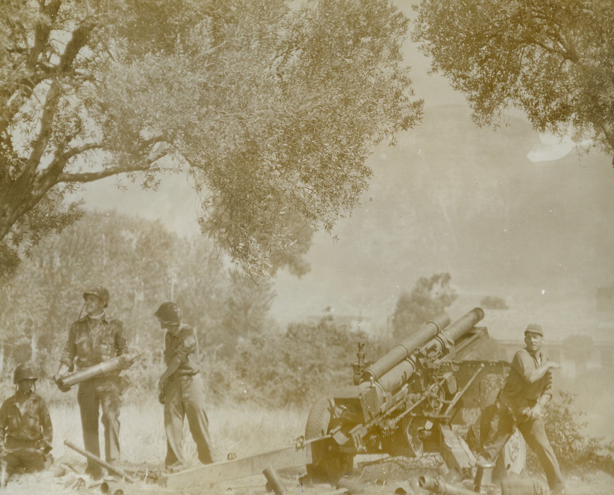 “And One for Sister Annie”, 9/24/1943. IN THE NAPLES AREA – “And one for sister Annie, “ yells Sgt. John C. Brunnett, of St. Paul, Minn., as he yanks the cord of a 105mm howitzer blasting enemy lines in the Naples area. Sgt. Brunnett labels each of the missiles he sends away – wreaking the vengeance of his entire family on the Axis gangsters. Credit Line – WP – (Photo by Charles Corte, Acme Photographer for War Pool);