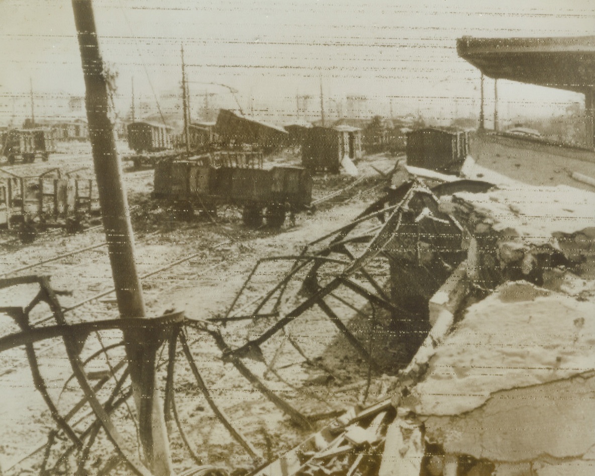 Ruined Railway Station, 9/26/1943. BATTIPAGLIA, ITALY – Target of both Allied bombers and German demolition squads, the railway station at Battipaglia lies in ruins. Battered, twisted steel forms the wreckage shown in this photo, radioed to New York from Algiers today (Sept. 20th) Credit (British Army Photo via OWI Radiophoto from Acme);