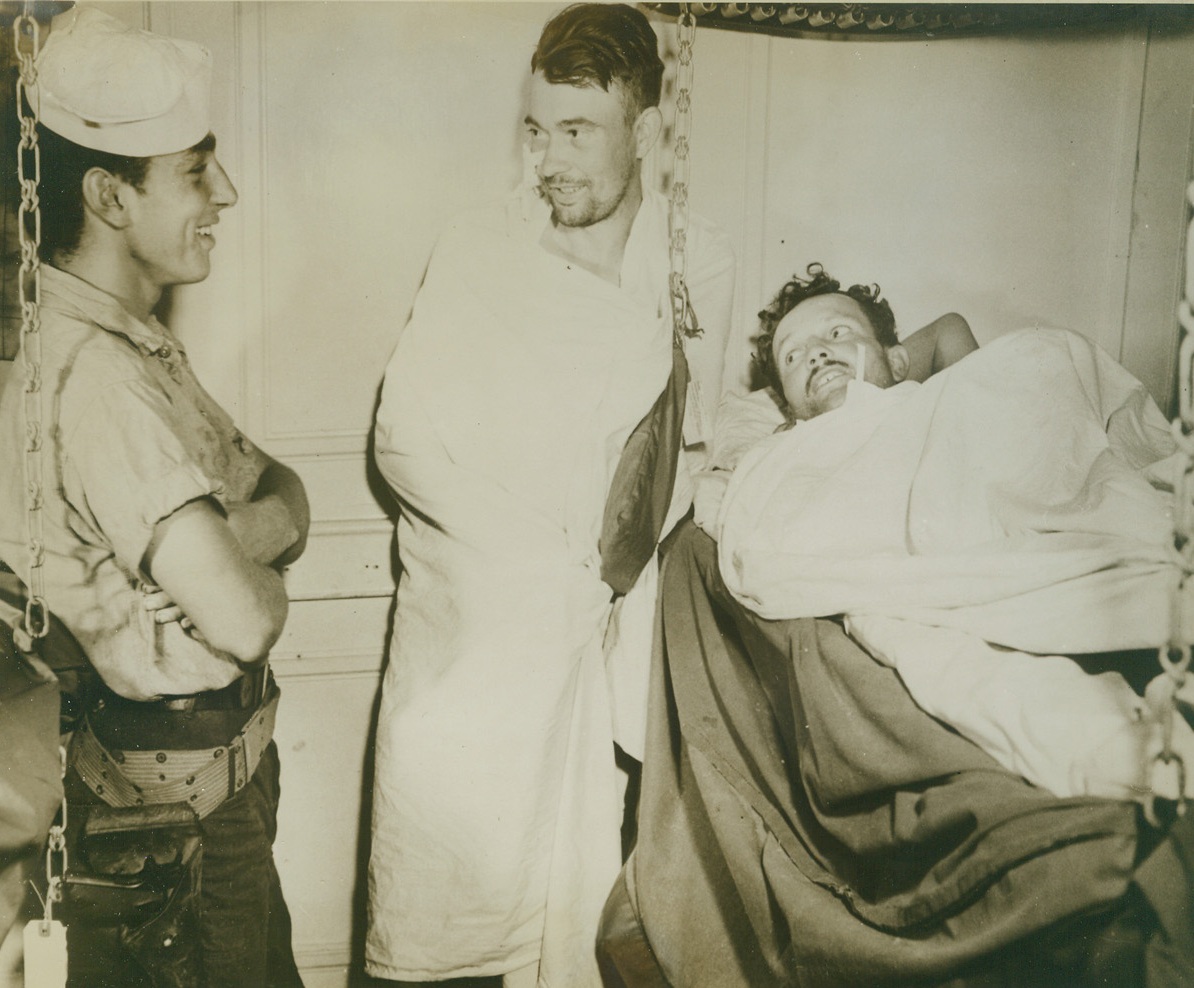 Hey, Hitler! A Jewish Sailor Guards Nazis!, 9/23/1943. OFF SALERNO – Bernard Leshner, (left), gunners’ mate third class of Philadelphia, Pa., stands guard over two slightly wounded Nazi prisoners aboard a U.S. transport manned by Coast Guardsmen, off the beach at Salerno, Italy. The two smiling Nazis were members of the 16th Panzer Division and were captured by the Allies in the hot fighting at Salerno. Credit Line (U.S. Coast Guard Photo from Acme);