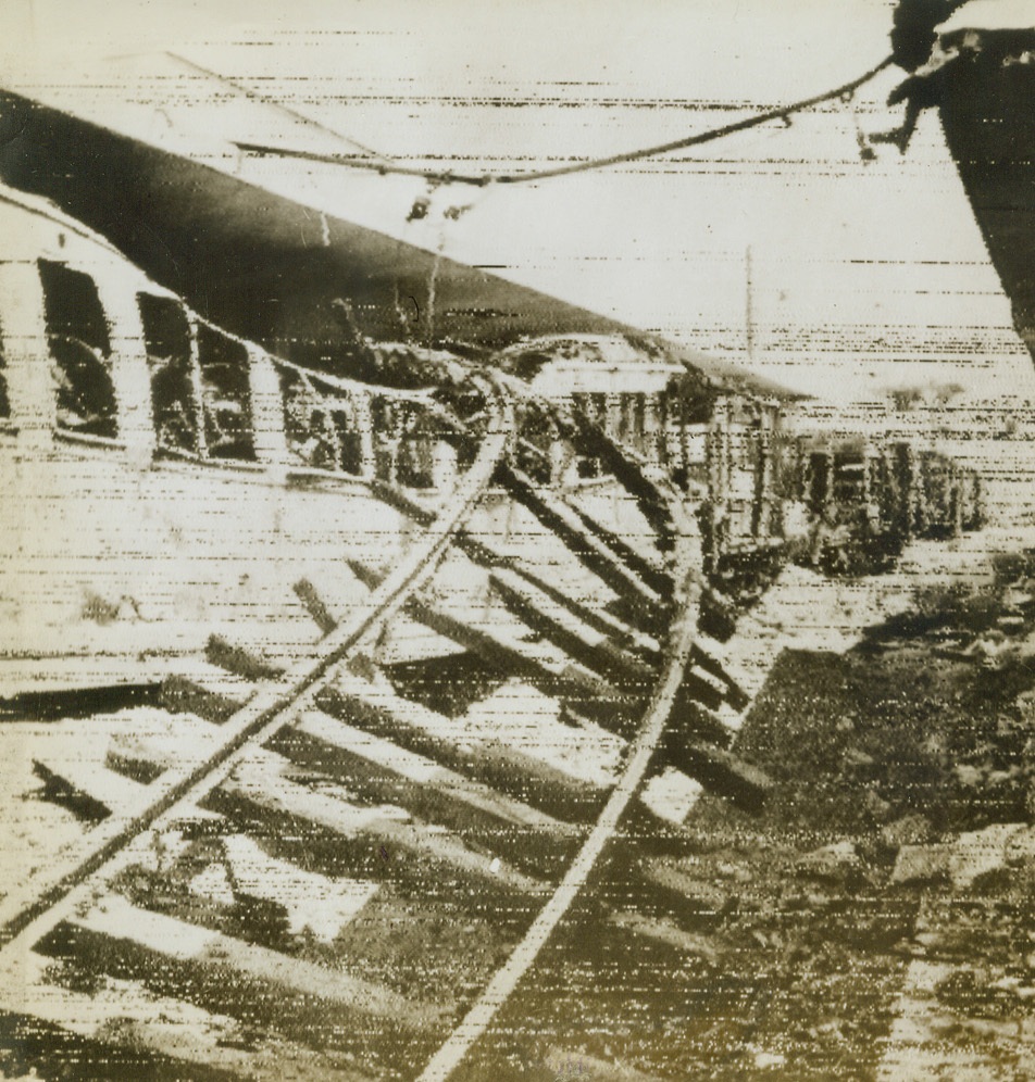 Leapfrog, 9/12/1943. SAN GIOVANNI, ITALY – The train jumped the tracks then the tracks jumped the train in a wartime game of leapfrog when Allied bombers scored a direct hit on the railway running through San Giovanni. Photo radioed to New York today (September 12th).Credit (British Army – OWI Radiophoto from Acme);