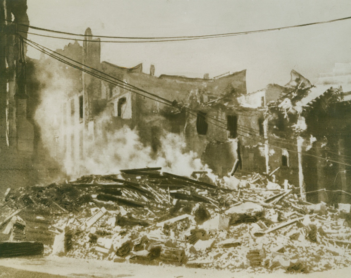 Still the Best Method of Persuasion, 9/10/1943. MILAN – Words of reason, entreaty or threat had no effect on our fascist enemies until we started to back them up with destructive force. Typical of that force is the bombing of Milan, chief railroad center of northern Italy. Here is the Piazza San Carlo in Milan as it appeared after one of the raids.Credit Line (Acme) WP;