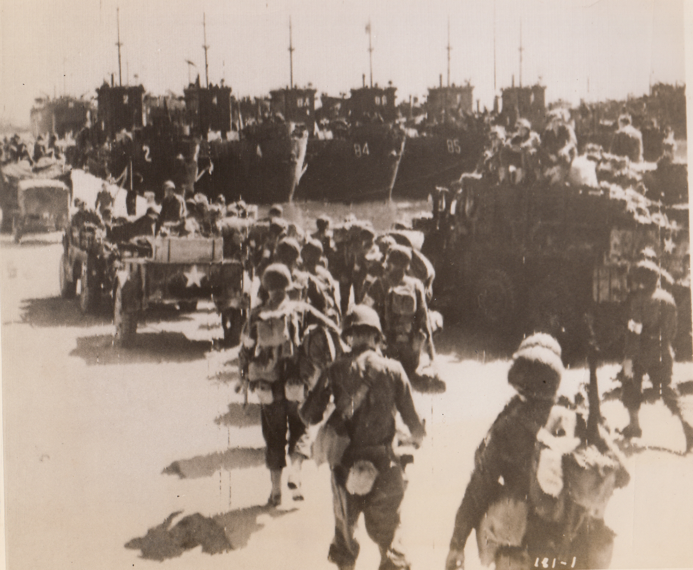 U.S. Soldiers Get Set for Italy, 9/10/1943. Bunches of L.C.I.’s await boarding by these American fighters at an unnamed Mediterranean port. Their destination? Italy, where more than a few Nazis need some rough treatment.;