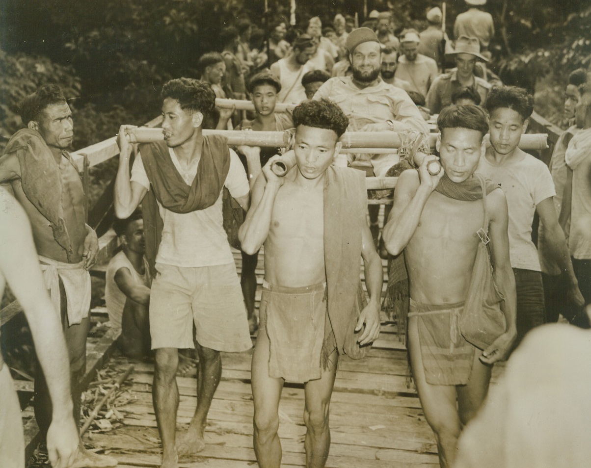 Plane Crash Party Cracks Jungle, 9/28/1943. India: - Almost a month had passed before survivor of an ATC plane crash in Northern Burma broke out of the jungle to a post in India.  Sgt. Walter R. Oswalt, Ansonia, Ohio, who was radio operator on ill-fated plane, is carried by natives on a primitive stretcher since he broke his leg while parachuting to Earth.  Other members of the planes complement bring up the rear with rescuers, who came both by air and over land.  Only the plane’s co-pilot died in the accident, all others parachuting safely to Earth when the ship developed engine trouble on a flight from China to India. Credit (photo by Frank Cancellare, photographer for the War Pool from ACME);