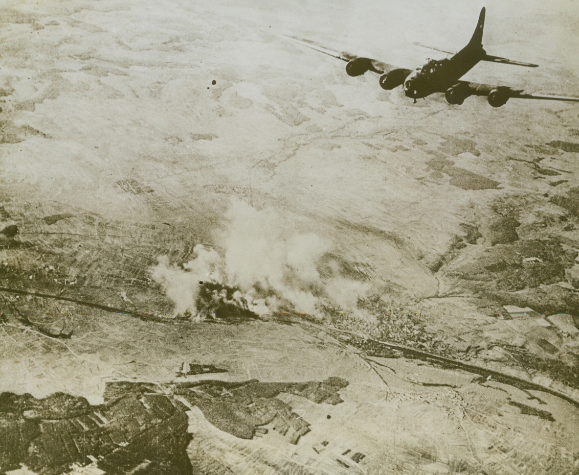 YANKS CRIPPLE ANOTHER NAZI INDUSTRY, 10/26/1943. This photo, just released in Washington, shows the important ball bearing producing city of Schweinfurt, Bavaria, in flames after a heavy raid last Oct. 14th by Flying Fortresses of the U.S. 8th Air Force. The factories, producing this most important part of Hitler’s war machine, were left in ruins. To indicate the size of the raiding force, 60 Fortresses were lost—only a fraction of the number of planes taking part. Yank gunners in the Forts and the P-47 Thunderbolts that accompanied them part of the way, shot down 99 enemy fighter planes, with 26 probables and 17 damaged. Credit: U.S. Army Air Forces photo from Acme;