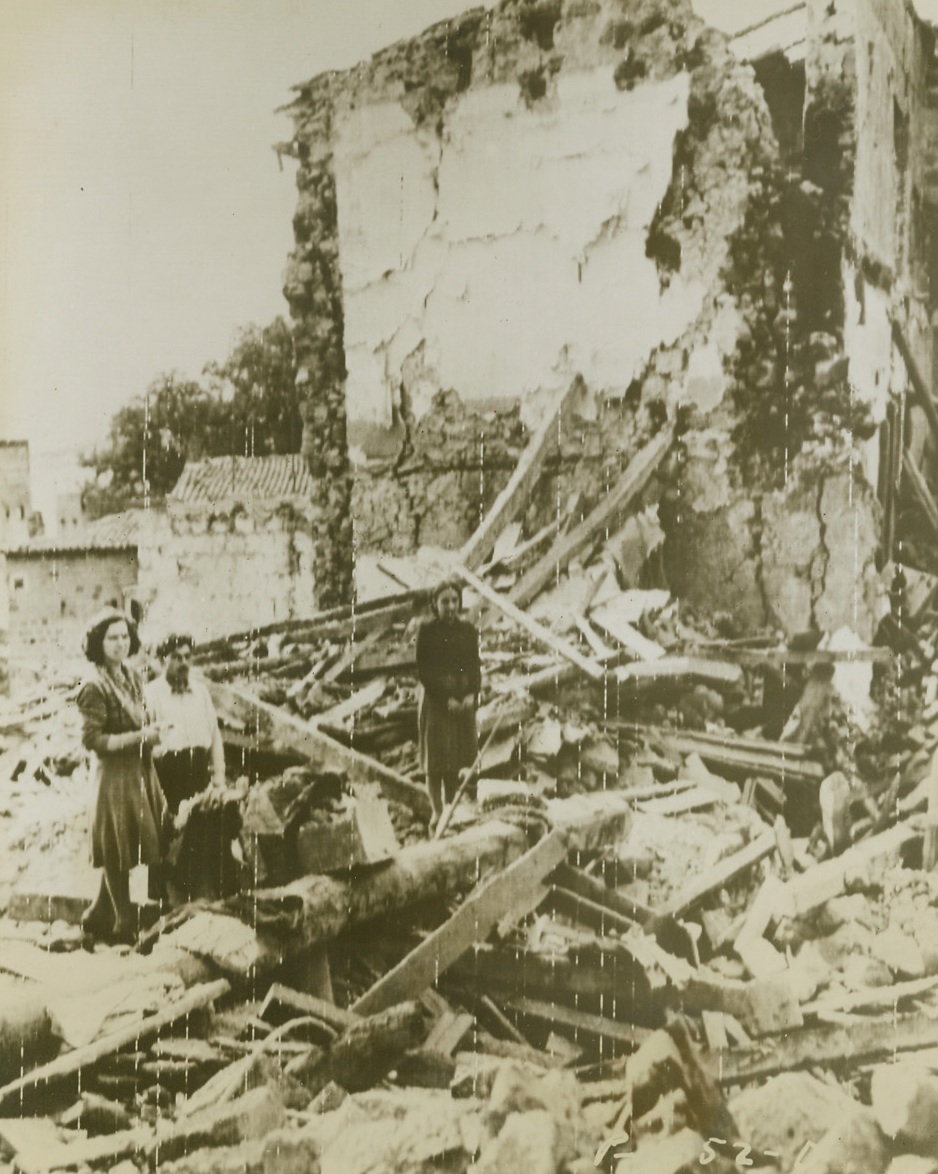 BATTLE WRECKAGE, 10/23/1943. This family returned to what remains of their home after the battle for Faicchio, Italy, was won by Allied troops. Credit: Signal Corps radiotelephoto from Acme;