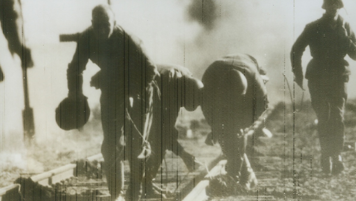 Nazis Practice Scorched Earth Policy, 10/29/1943. Russia – The Nazis must remember how effective the Russian scorched earth policy was when they were advancing so now that they’re retreating, they’ve decided to do likewise. German sappers are shown blowing up rail lines as they retreat. According to German caption, they are placing explosive charges every five meters. Photo radioed from Stockholm today.Credit: ACME Radiophoto;