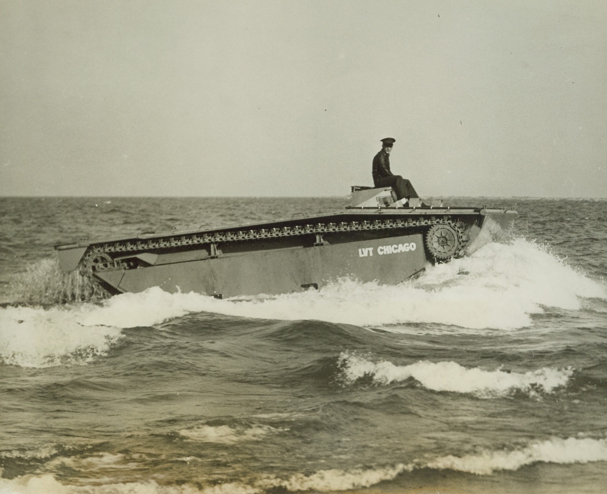 First Public Demonstration of “Water Buffalo”, 10/9/1943. Chicago - The New “Water Buffalo” developed by the U.S. Marine Corps, as the successor to the famous “Alligator” used in landing operations at Attu, Sicily, Solomons, and the Italian mainland, brought to Chicago for current war loan drive show, is shown as it entered Lake Michigan during its first public appearance. The LVT or “Landing Vehicle Tractor”, built by Borg-Warner Corp., is driven by members of the Marine Amphibian Tractor Detachment from Dunedin, Fla. Credit: ACME;