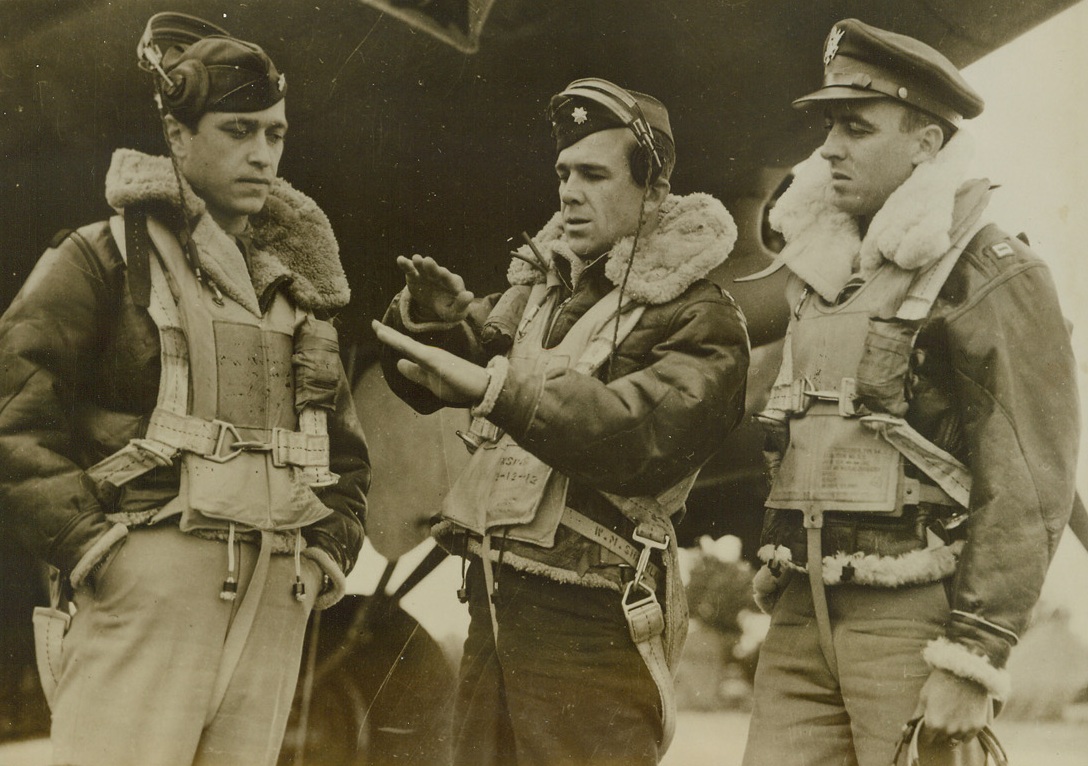 AIRMEN’S KINDERGARTEN, 10/7/1943. ENGLAND—These are some of the men who are doing an expert job of bombing Europe from their “Kindergarten Station” in England. The Station won its name because every member of its staff is under the age of 30. Left to right are: Major William Tesla, 25, of Pittsburgh, Pa; Major Septime S. Richard of Jackson, Miss., who, at 29, is “old man” of the group; and Capt. Archie Benner, 25, of El Paso, Texas. Credit Line (ACME);