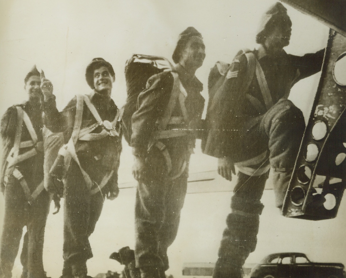 GREEK CHUTISTS OFF TO SAMOS, 11/15/1943. MIDDLE EAST—“Do Or Die” Greek parachutists climb aboard a transport which will fly them to Samos Island, where they are now reinforcing the Allies who are battling Nazi invaders. The Greek Sacred Brigade has traditions dating back 2,000 years when its slogan was “come back victorious or dead.” Credit: Acme Radiophoto;