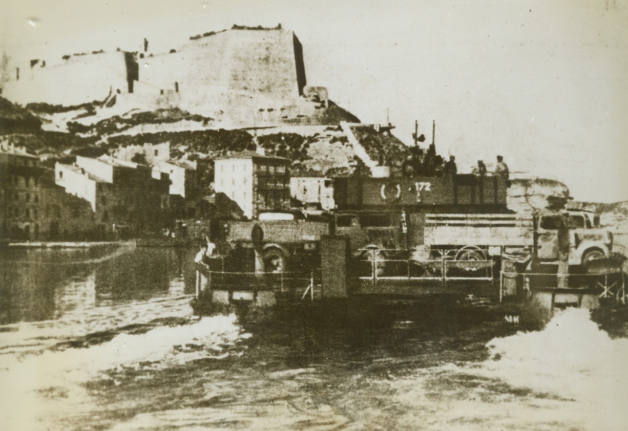 EVACUATING CORSICA, 11/21/1943. CORSICA—Ferry evacuating the island of Corsica and bound for mainland of Italy is crammed with trucks and men, according caption accompanying this German photo taken from the Munich Illustrierte Presse and received through a neutral source. Credit Line (ACME);