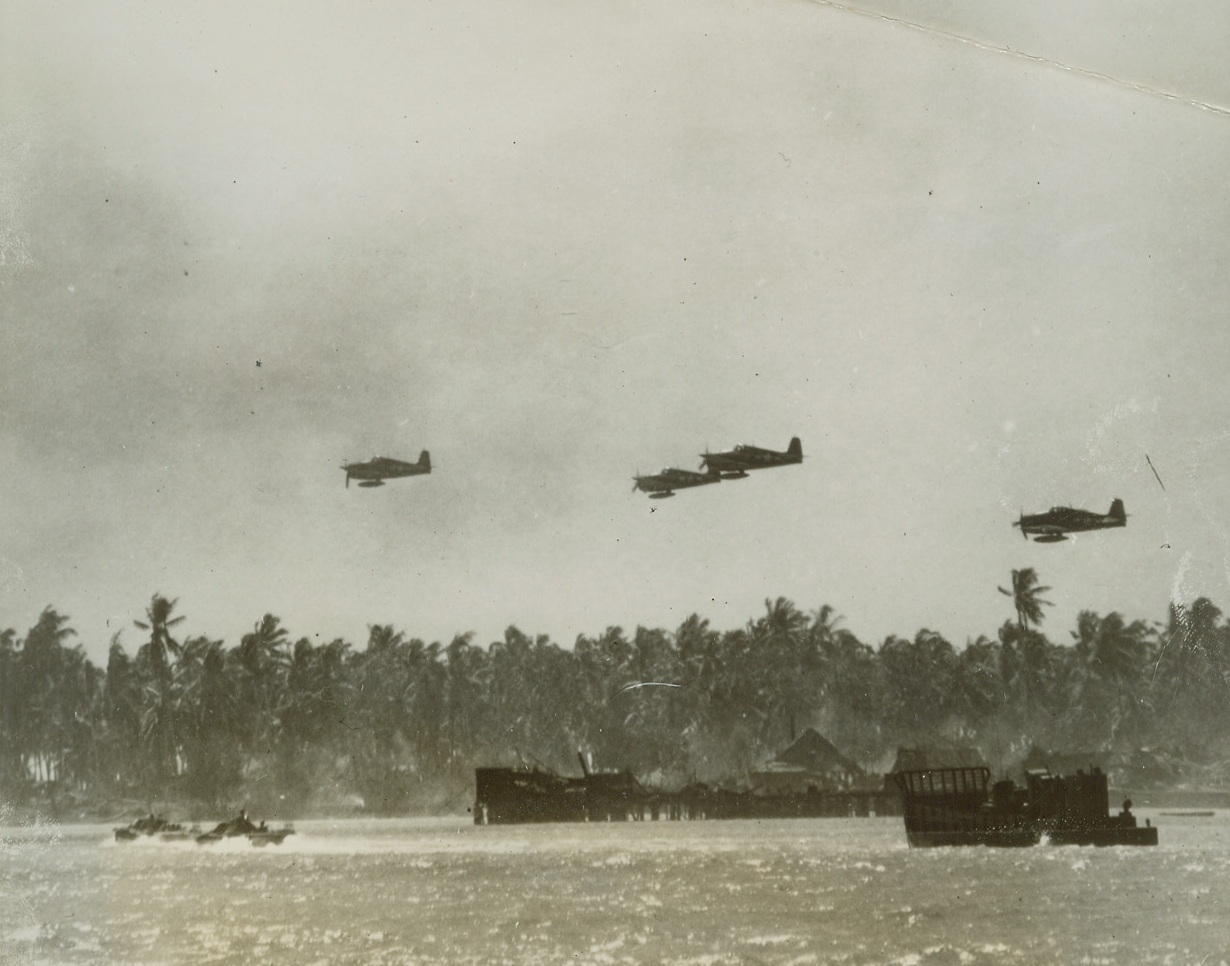 Air, Sea Assault Spearheads Yank Invasion of Makin, 12/3/1943. CME; MAKIN, G.I.—In one of the first Makin Island action pictures to reach the United States, American planes come in low over their own invasion craft to strafe Japanese machine gun nests on the enemy-held Gilbert base. This photo was made as the first wave of our assault troops moved in on the Japs on November 21. Credit;