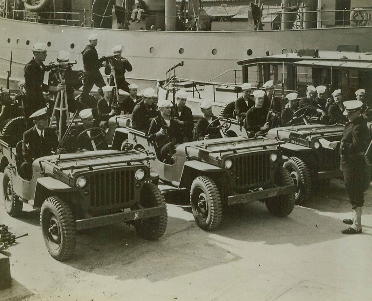 Anti-Saboteur Patrol, 10/20/1942. An East Coast Port—Vital cargoes of war supplies for America’s far flung battle lines must be protected on the docks as well as at sea. Here, Coast guardsmen of the anti-saboteur patrol receive their orders at “An East Coast Port” before starting out on patrol.Credit: U.S. Coast Guard photo from ACME.;