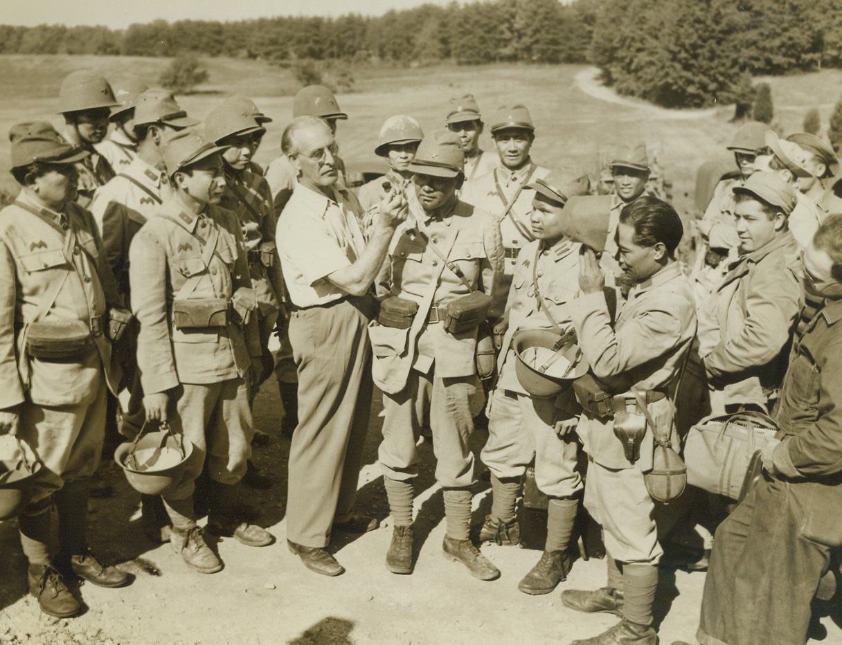 Yanks Get Taste of “The Big Show”, 10/12/1942. Fort Belvoir – Soldiers at Fort Belvoir got a taste of what’s ahead of them when Warner Bros. staged a battle there for the forthcoming government picture “The Fighting Engineers.” As Japanese, to play the part of Jap soldiers in the film, were a bit scarce in the neighborhood, 50 Filipinos were brought in to play the parts of the “enemy.” So realistic were the battle scenes and so well were the “Japs” made up that the U.S. soldiers had to be cautioned continually to go easy with their bayonets. To make it ever more realistic, battle scenes were staged in a section of Fort Belvoir that closely resembles the terrain of the Solomon Islands. The U.S. soldiers, of course, were the victors in the movie. Here, a series of photos taken during the filming is presented.  New York Bureau Filipinos are made up for their roles as Jap soldiers. They are equipped with authentic Japanese uniforms and insignia and “wounds” are applied by a makeup man to make the scenes more realistic. Credit: ACM;