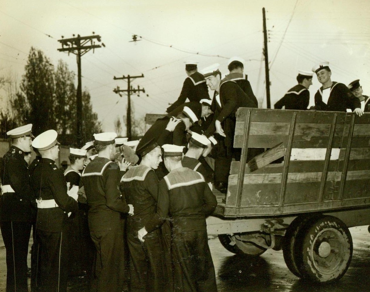 British Sailors Harvest American Crops, 10/23/1942. English sailors on leave from a British Man o’ War that is in a U.S. Navy yard for refitting lend a hand to Virginia truck and dairy farmers sorely in need of farm manpower. Shore leave became a new kind of holiday in the country with the British lads pitching in to help harvest hay and soybean crops. Many of these sailors have been at sea for two years, and found it a real treat to be ashore again. The British Navy would not let them accept pay for their work, but there was no objection to spending their leave in American country homes and, in return, being royally entertained. Here, sailors board a truck en route to a farm. Credit: ACME;