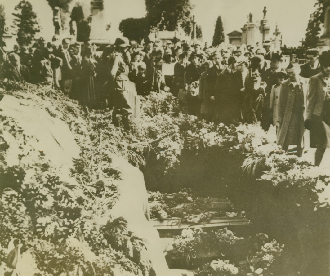 Belgians Pay Homage to British Airmen, 11/10/1942. BLAINE-LE COMTE, BELGIUM – German soldiers and guards could not prevent spontaneous demonstrations of Belgian citizens who buried RAF fighters who were shot down while raiding a Nazi-utilized Belgian railway producing center. Crowds of Belgians pass before the coffins to pay homage. Eleven German soldiers were killed and 24 others were wounded when the plane wreckage ignited a school used as Nazi military headquarters. Seven RAF fliers were buried by patriotic Belgians.Credit Line (Acme);