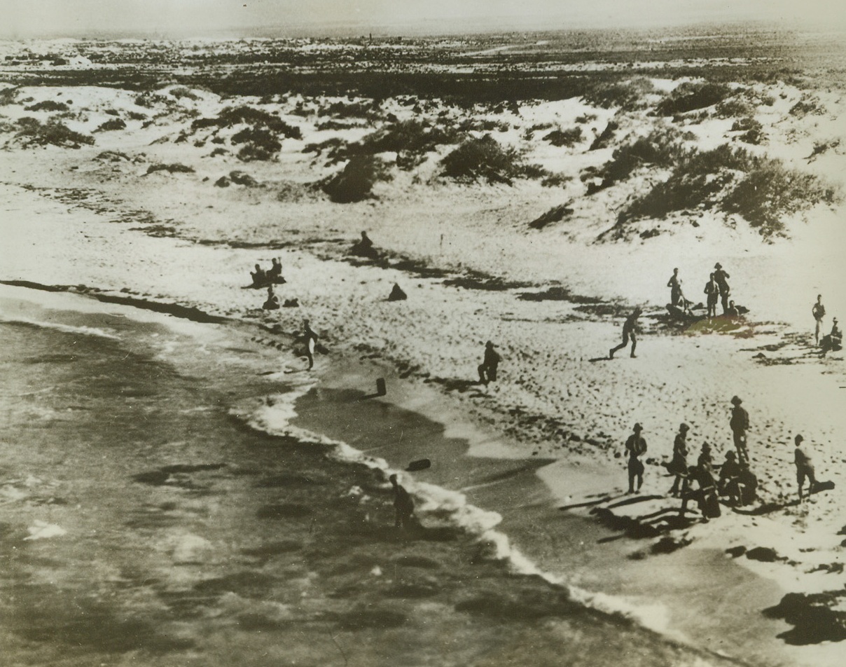 Axis Bathers Surprised by RAF, 11/10/1942. Libya—Axis troops bathing and washing their clothes at Gazala, on the western shore of the bay of Bomba, were surprised by four long-range fighters of the R.A.F. who shot up a nearby parade of enemy troops, killing approximately fifty. The same British fighters successfully attacked five enemy aircraft and four other Cant 506’s at the Libyan seaplane base in Bomba Bay, near Derna.Credit: ACME;