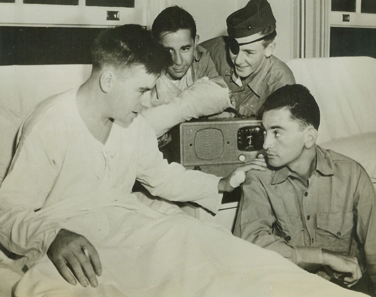 He Mowed Them Down!, 11/10/1942. San Diego, Calif.—Pvt. Albert A. Schmidt (in bed), USMC, from Philadelphia, Pa., was credited by comrades for killing more than 200 Japs with a scorching hot machine gun before an enemy grenade blinded him in the battle of Tenaru River on Guadalcanal Island. Here, Schmidt is shown talking at a San Diego Naval Hospital to Corp. Leroy Diamond (right foreground), of New York City, who fed the machine gun until he was wounded. Pvt. George McNally (rear right), of Evansville, Ind., whose arm is bandaged, and another unidentified Marine, listen to the conversation.Credit: U.S. Marine Corps photo from ACME.;