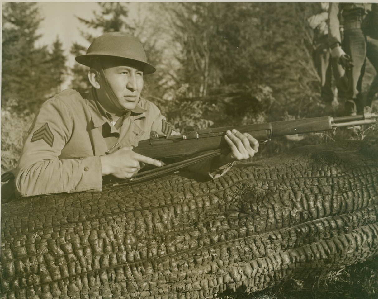 GOOD SCOUT, 2/7/1942. A Sioux Indian Scout of Uncle Sam’s Army looks out over the terrain “somewhere in the Pacific Northwest.” In this war as in World War I, the U.S. Army is using American Indians for scouting work. Credit: OWI Radiophoto from ACME;