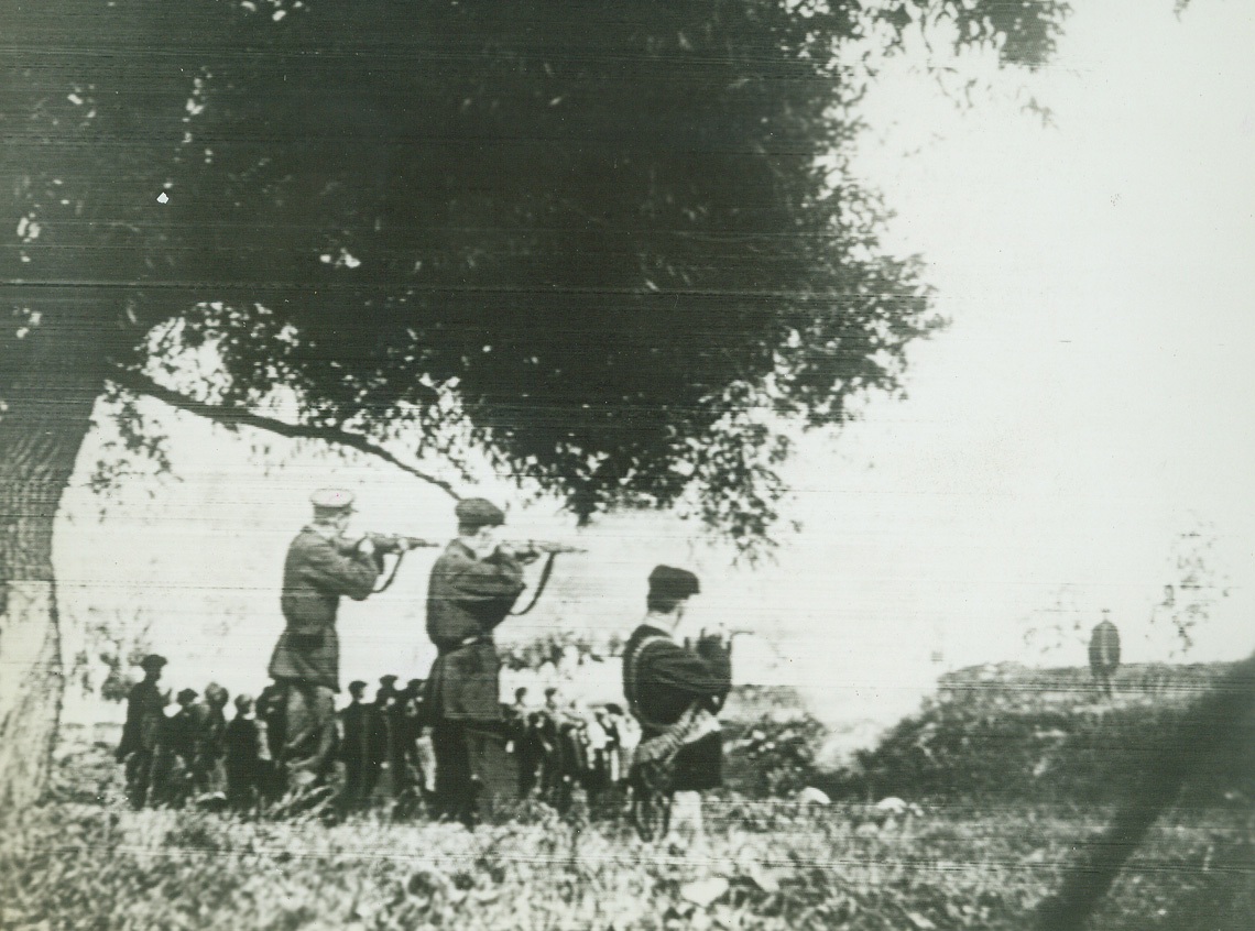 “March of Time”, 2/11/1942. (No. 3 in series) The village turns out to watch the execution of the fifth columnists whose perfidy cost lives of his fellow-villagers in the action in No.1.Credit: ACME Telephoto;