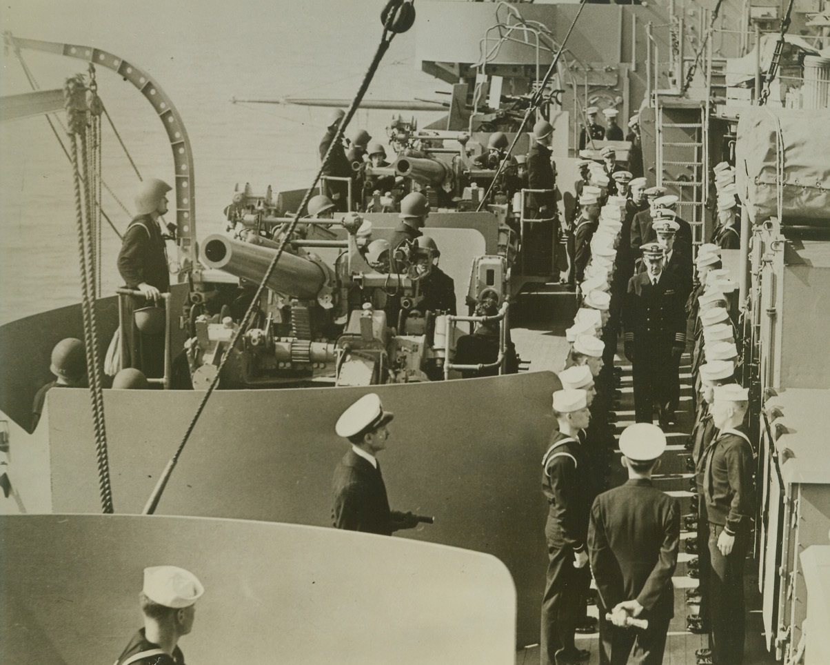 On Patrol With the Atlantic Fleet, 4/18/1942. At Sea—Early morning abroad one of the fighting ships of the U.S. Atlantic Fleet as it makes its sweep of the Atlantic, keeping ocean roads to our Allies in Europe clear of Marine gangsters. Here you see one party of gobs lined up for inspection by the skipper while others man the guns, ready to do business at a moment’s notice. Approved by U.S. Navy Credit: ACME.;