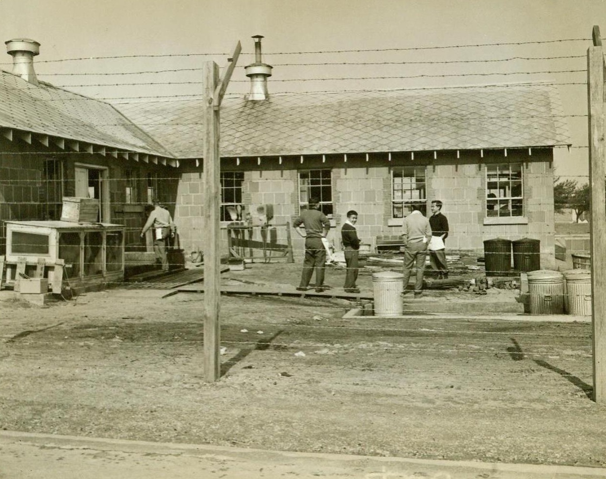 Enemy Aliens Interned At Maryland Fort, 4/2/1942. Several hundred German, Italian and Japanese nationals have been interned at Fort Meade, MD. They live in tents of the same type used by United States troops. They dine on the same fare. The different nationalities are separated within a high-wire enclosure. No visiting among groups is allowed. Site of the internment camp was formerly a training center for reserve officers. 4/2/42 (ACME);