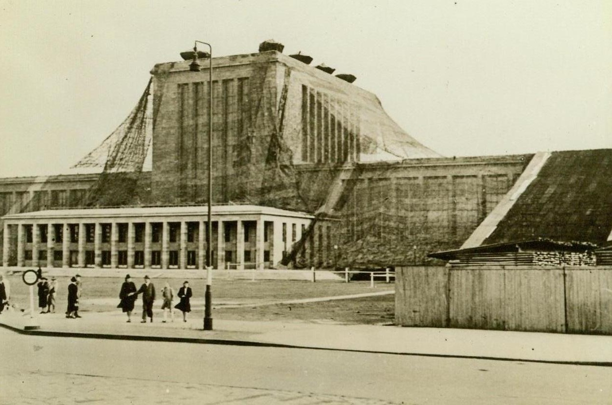 Berlin Under Camouflage, 7/7/1942. Berlin, Germany – The Nazis have undertaken extensive camouflage operations throughout the city to fool crack RAF Bombardiers. Here is a view of the camouflaged exposition halls on Kaiserdamm in Berlin. 7/7/42 (ACME);