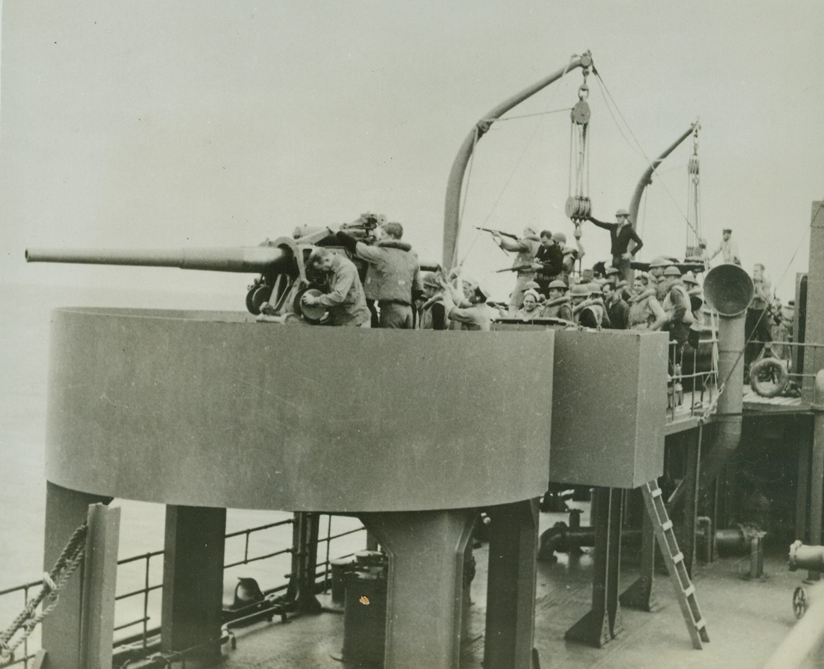 Tense Moment on a U.S. Tanker in a Convoy, 8/4/1942. Life-jacketed U.S. sailors leap to their guns as a submarine alarm is sounded on a naval tanker in a convoy somewhere in the Indian ocean. Credit line (ACME);