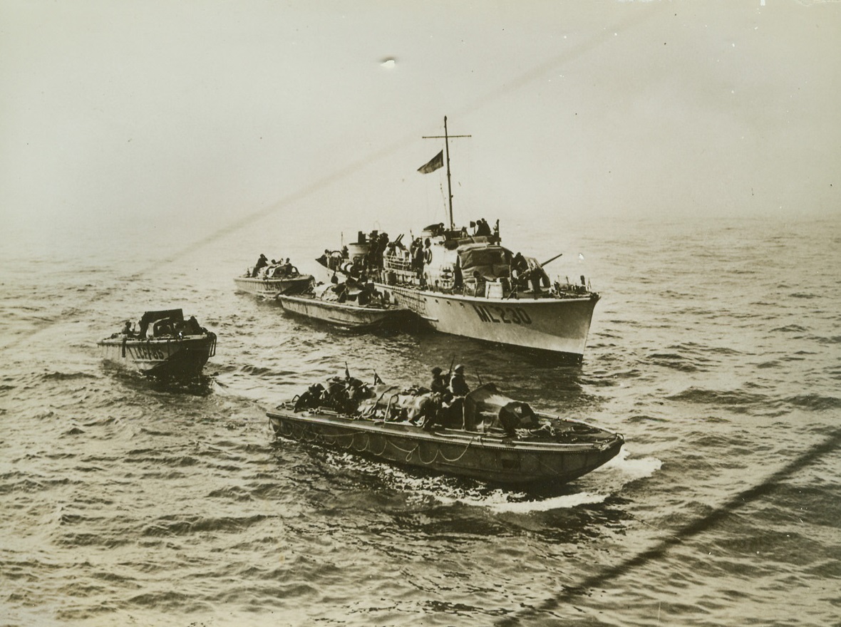 Dieppe Raid- A Miracle of Cooperation, 8/27/1942. The raid on the French coastal town of Dieppe, August 19, by United Kingdom Commandos and American Rangers, was a miracle of cooperation of land, sea and air forces. The R.A.F., U.S. Army Air Forces, and Royal Navy worked hand in hand to effect the landing of the raiders. Here, a Royal Navy Launch watches over four of the many landing craft used during the raid. (Passed by Censors) Credit: ACME;