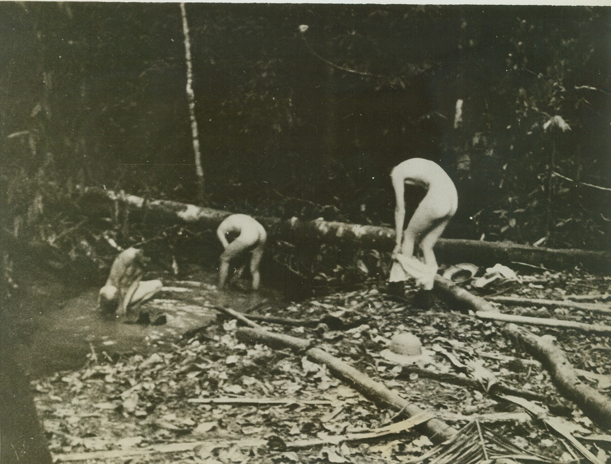 Cleanliness is observed, 8/8/1942. Cleanliness is observed in spite of jungle flies and other pests. “Yank” correspondent Ed Cunningham took this photo of some of the men washing their clothes—and themselves—in one of the small streams. Credit: ACME;