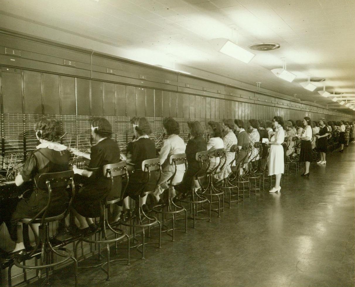 Phones of War at Work, 9/15/1942. Arlington, VA.—View of a section of the switch-board at the telephone exchange in the War Department’s new office building here, just across the Potomac from Washington. In this building and others it occupies in the District of Columbia, the War Department has four times the telephone facilities it used in the First World War—An exchange large enough to serve a city the size of Erie, PA. 9/15/42 (ACME);