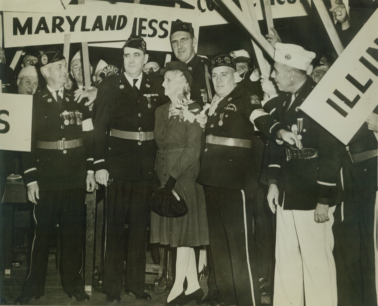 ROANE WARING NEW LEGION COMMANDER, 9/22/1942. KANSAS CITY, MO. – Col. Roane Waring of Memphis, Tenn., and his wife are shown standing on platform of Kansas City Municipal Auditorium after the American Legion had named him National Commander. The new Commander and wife are in center surrounded by delegates holding state standards. Credit: ACME;