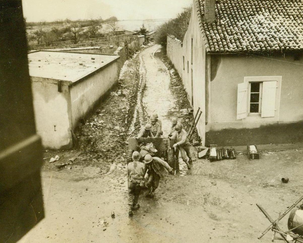 Slip and Slide To A New Position, 11/23/1944. Pouilly, France - Slipping and sliding as they push and pull at their 57mm anti-tank gun, these Third Army fighters find mud an unrelenting enemy as they move to a new position during the battle for Pouilly. Credit: ACME;