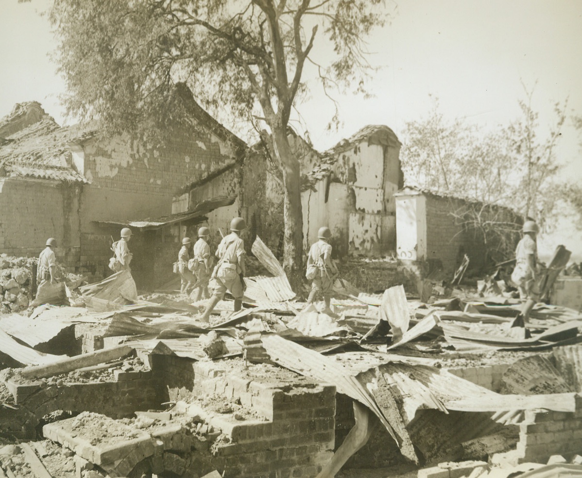 Chinese Mop Up, 12/30/1944. Bhamo, Burma – Victorious after a month-long battle for Bhamo, one of the last remaining Jap strongholds along the new India-to-China overland supply route, American-trained move through the ruins of Bhamo.  With the core of Jap resistance broken, they complete mopping up operations in the area.  Photo by Frank Cancellare, ACME photographer for the War Picture Pool. Credit line –WP—(ACME);