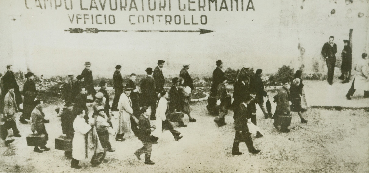 SLAVE LABOR FOR REICH, 1/20/1944. One of the first acts of the Germans after they had taken over in Northern Italy, was to collect thousands of able-bodied male and female Italians and to send them to the Reich to work in Nazi war plants. In this photo, received in New York from a neutral source today, a group of Italians setting out for German labor camps. Credit: Acme;