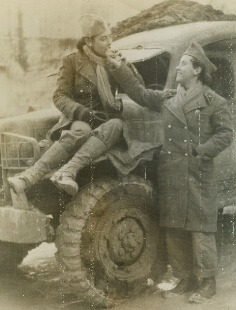 Frenchwomen at the Front, 1/1/1944. Frenchwomen at the FrontON THE ITALIAN FRONT -- Wearing clothing that isn’t much different than the togs sported by these women are ambulance drivers on the Fifth Army front in Italy. Both daughters of France, Naneu Calas (left) and Cecille Gedgeon stop to munch a chocolate bar in an Italian village. Photo radioed to New York January 1st from Algiers. Credit: OWI RADIOPHOTO FROM ACME.;