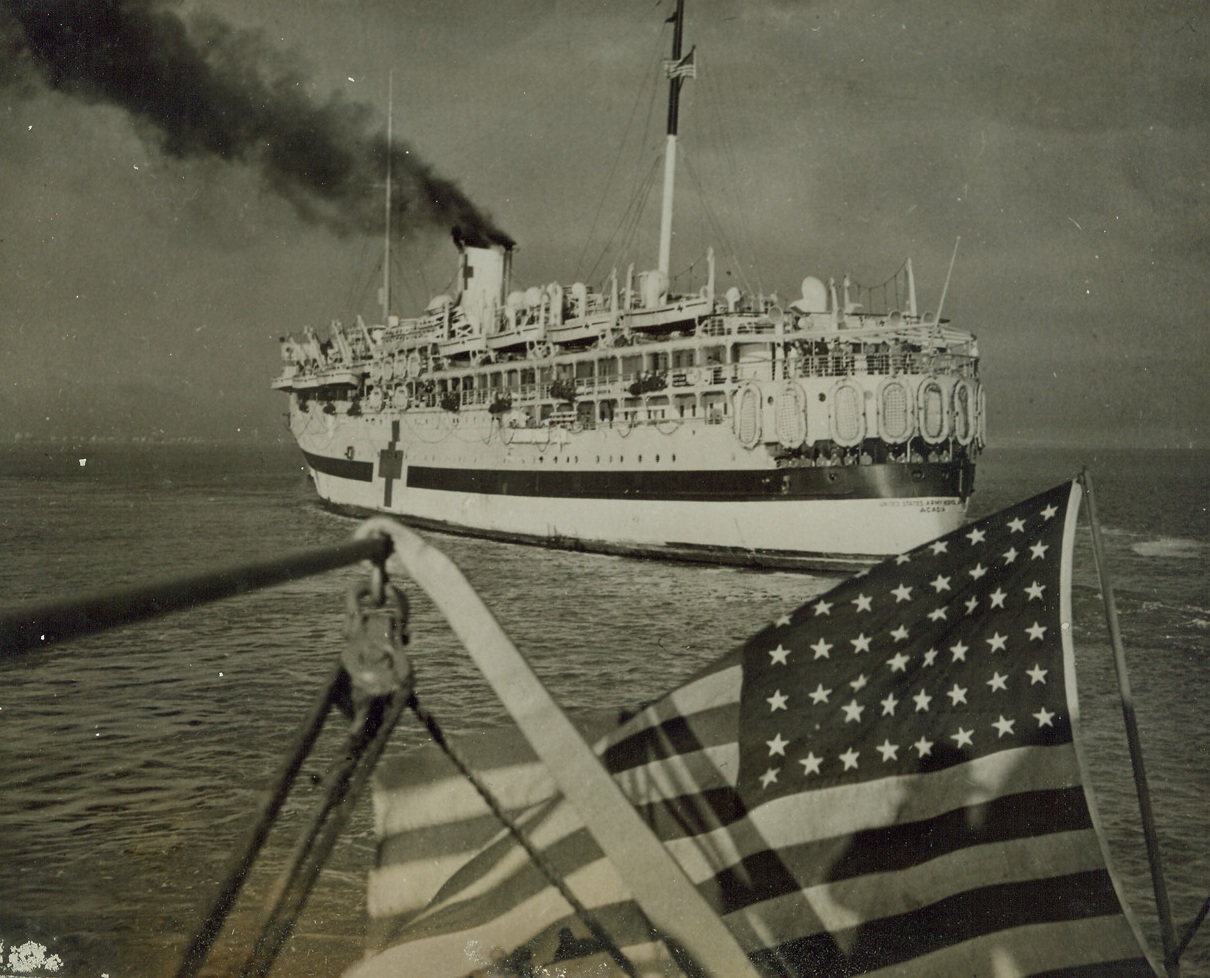 She Brought Happy Warriors Home, 1/8/1944. AT AN EAST COAST PORT -- Steaming into an East coast port with her precious cargo on January 5th, the U.S. Army hospital ship Acadia brings a batch of wounded, but happy Yanks back to their homeland. The vessel carried casualties from North Africa, Italy and Europe, who were sent to Hospitals for treatment as soon as they debarked. Credit: ACME.;