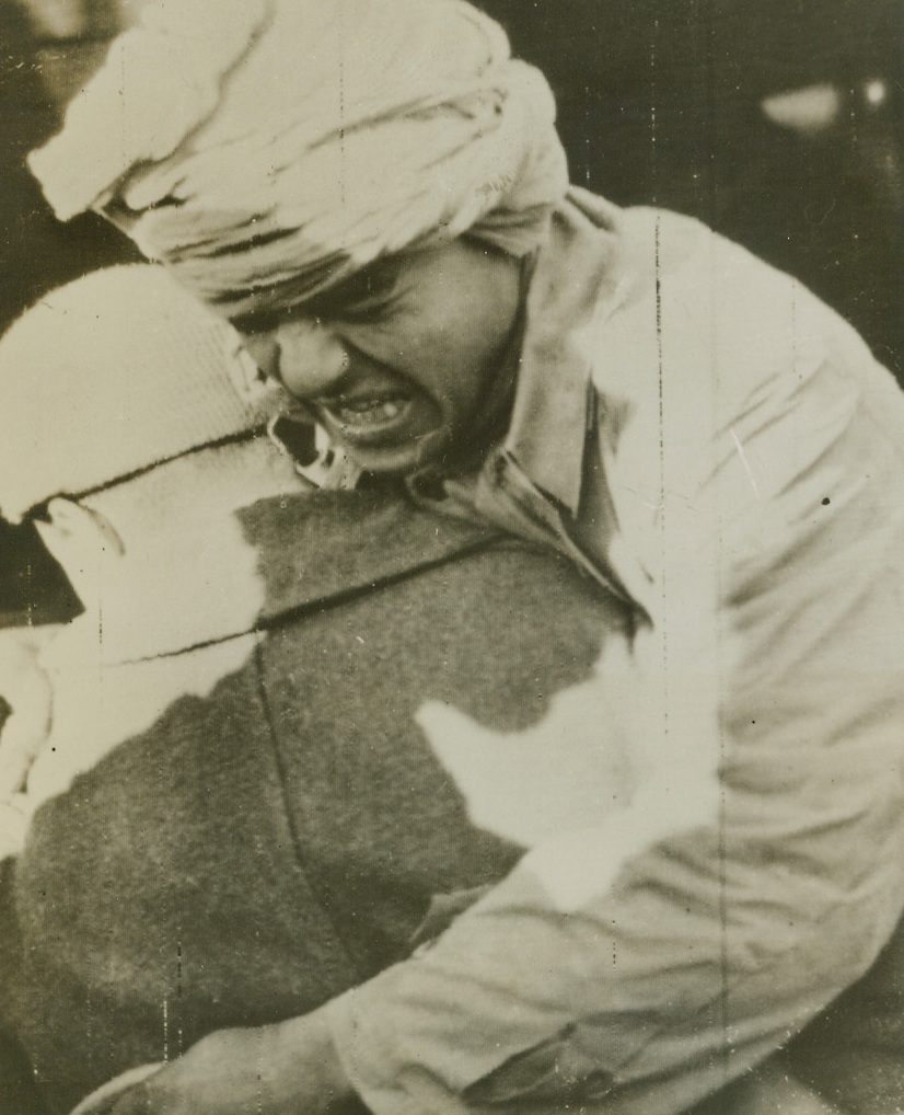 Pain, 1/5/1944. WITH THE FIFTH ARMY -- Wounded while fighting with the Allied Fifth on the Italian front, a French Goumier grimaces with pain as he is carried from an ambulance to an emergency dressing station close behind the lines. Photo radioed to New York from Algiers Jan. 5, 1944. Credit: STARS AND STRIPES PHOTO via OWI-ACME.;