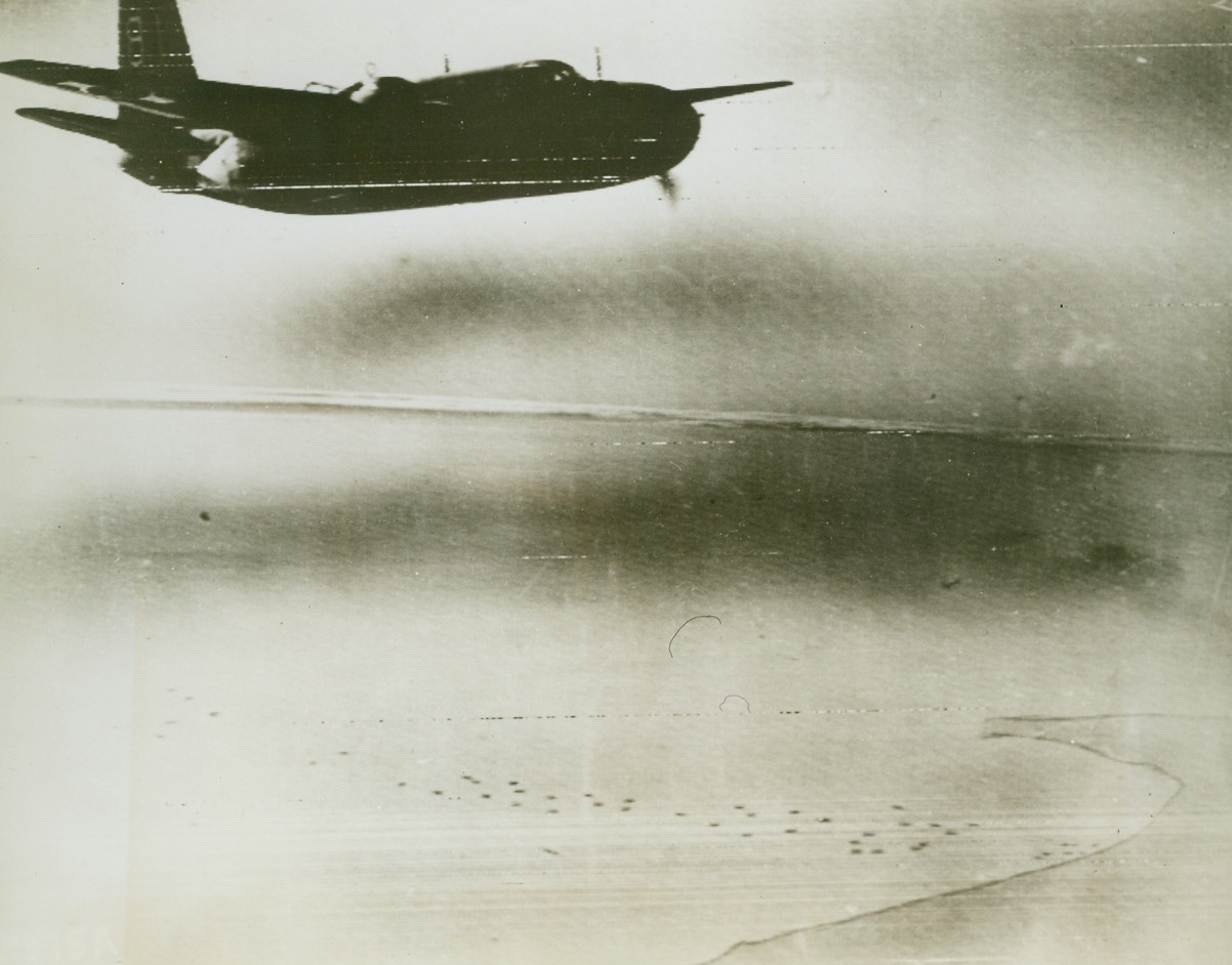 COVERING ALLIED BEACHHEAD NEAR ROME, 1/25/1944. An [sic] plane of the U.S. Army Air Forces flies protectively over the spot south of Rome where Allies have made new landings bypassing German forces in the Cassino area. Far below can be seen craft landing American and British supplies and reinforcements. Today, the Germans abandoned Cassino to the Allies.Credit: Acme photo by Charles Seawood for the War Picture Pool via Army Radiotelephoto;