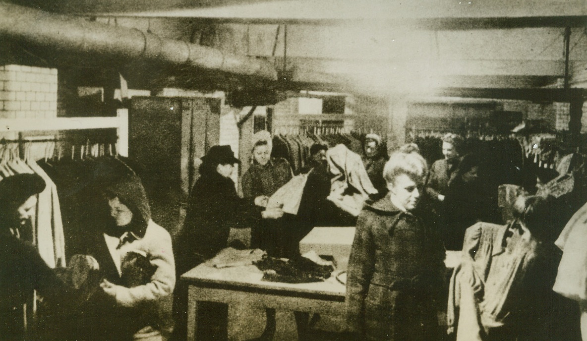 Cellar Shoppers, 1/16/1944. BERLIN – Shopping in the basement of a Berlin store, these German women aren’t bargain-hunting. It’s just about the only place they can shop in the bomb-blasted city. Retail store owners salvaging what they could from the piles of bombed shops, have moved to their cellars, where they still sell to a limited number of customers. Credit Line (ACME);